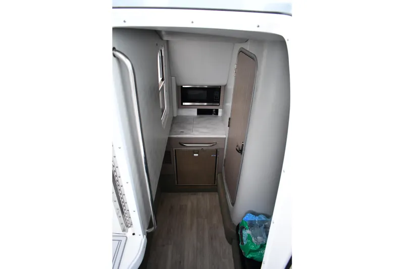 Slide: The Image of 2018 Formula 350 FX Crossover Bowrider cabin interior with kitchenette and storage. - 15
