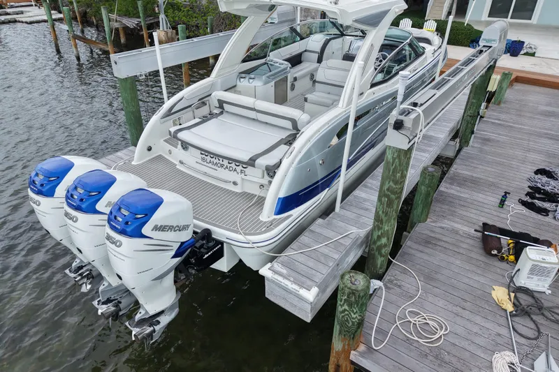 Slide: The Image of 2018 Formula 350 FX Crossover Bowrider docked with triple Mercury outboard engines. - 6