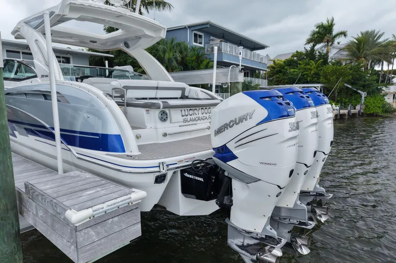 Slide: The Image of 2018 Formula 350 FX Crossover Bowrider with Mercury engines docked by waterfront homes. - 7