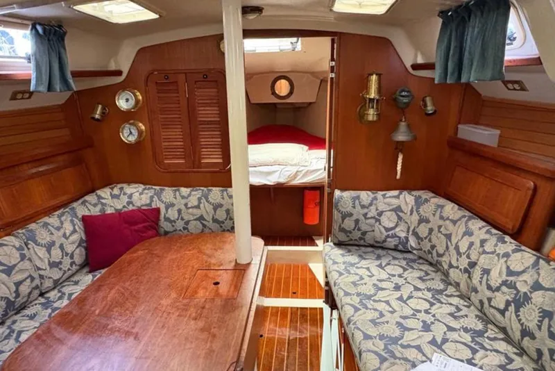 Slide: The Image of Interior of 1991 Hunter Legend 37.5 sailboat with cozy seating and wooden finishes. - 10