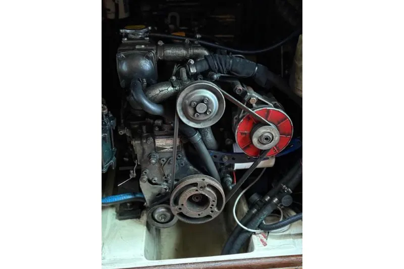 Slide: The Image of Engine of a 1991 Hunter Legend 37.5 sailboat, showcasing belts and components. - 13