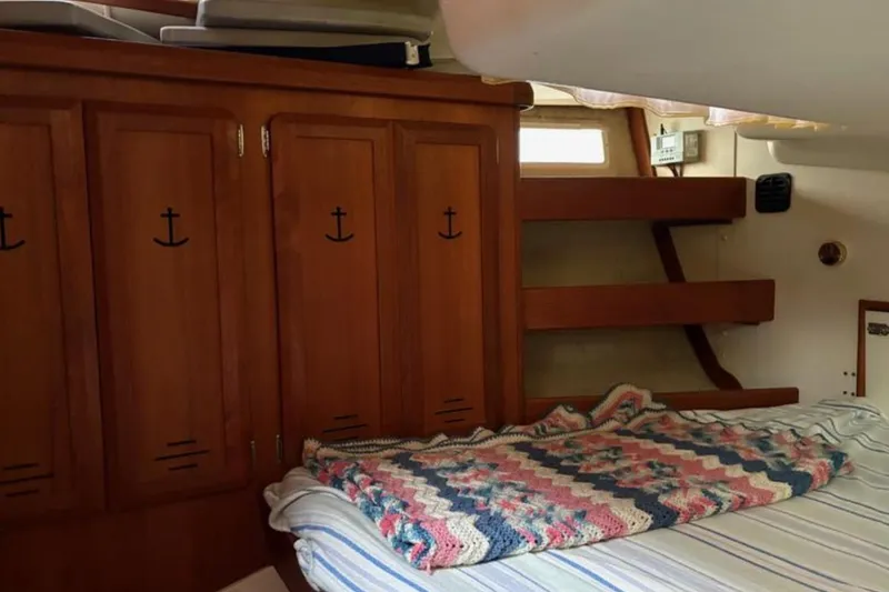 Slide: The Image of Cozy cabin interior of 1991 Hunter Legend 37.5 sailboat with wooden cabinets and bed. - 14