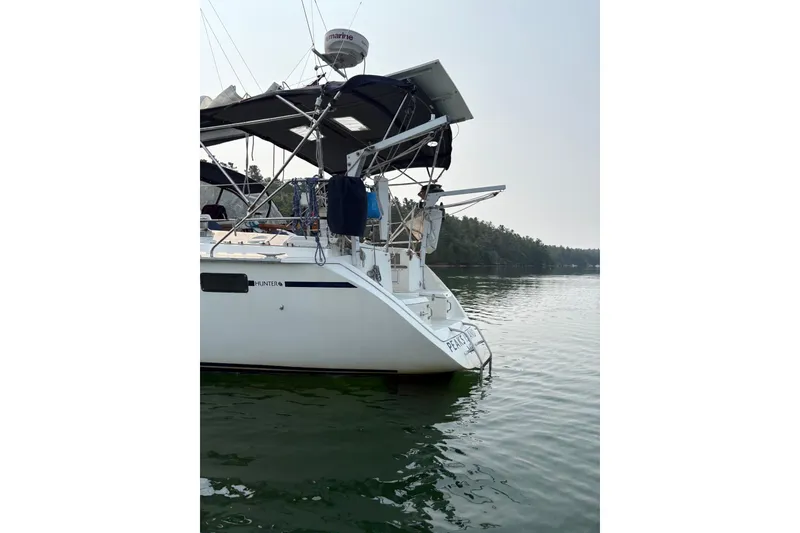 Slide: The Image of Hunter Legend 37.5 sailboat from 1991 on calm water, featuring a sleek design. - 3