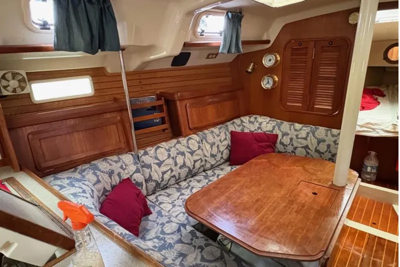 Slide: The Image of Interior of 1991 Hunter Legend 37.5 sailboat with cozy seating and wooden table. - 9
