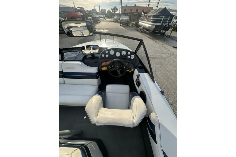 Slide: The Image of 1992 Correct Craft Ski Nautique boat interior with steering wheel and dashboard view. - 12