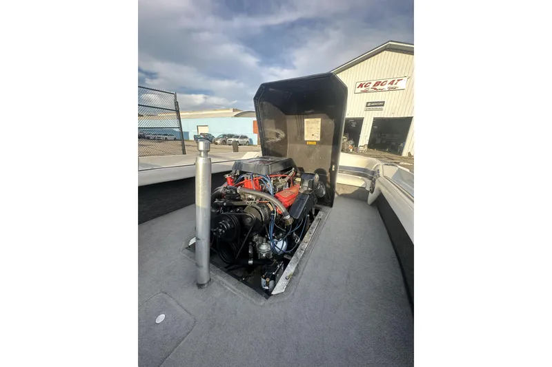 Slide: The Image of 1992 Correct Craft Ski Nautique engine compartment open, showcasing the boat's engine. - 16