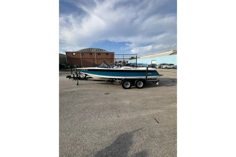 Slide: The Image of 1992 Correct Craft Ski Nautique boat on trailer in parking lot. - 3