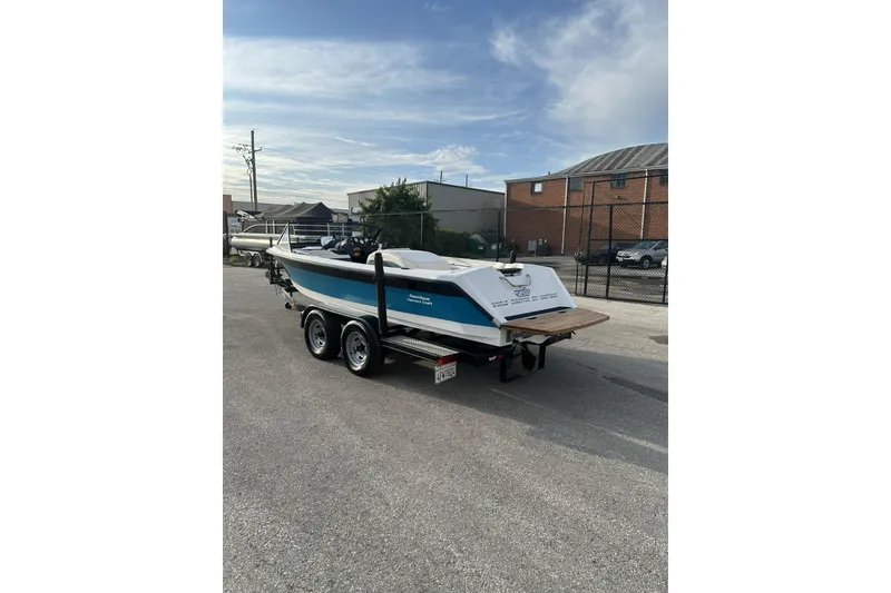 Slide: The Image of 1992 Correct Craft Ski Nautique boat on trailer in parking lot. - 4