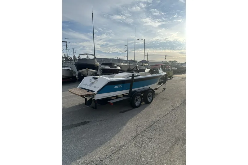 Slide: The Image of 1992 Correct Craft Ski Nautique boat on trailer in marina parking lot. - 6