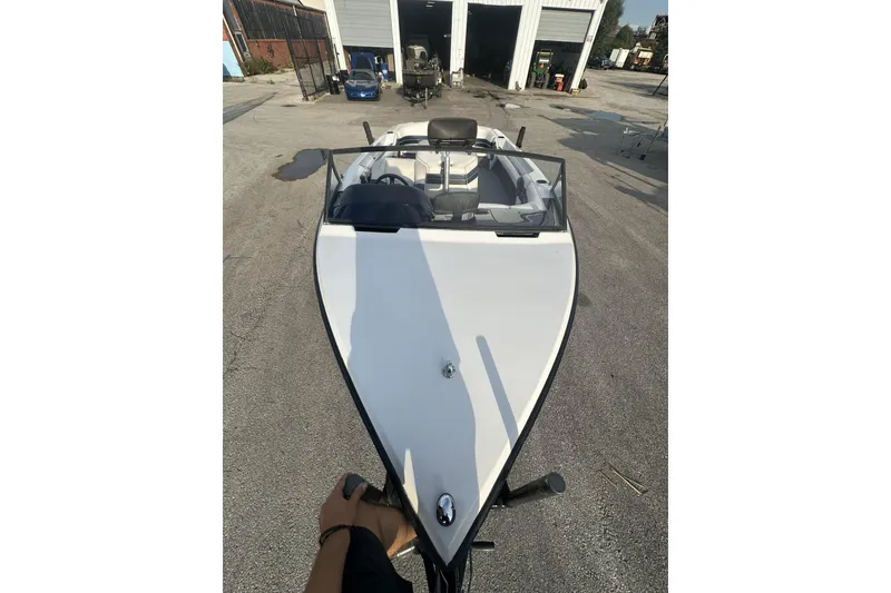 Slide: The Image of 1992 Correct Craft Ski Nautique boat parked outside a garage on a sunny day. - 8