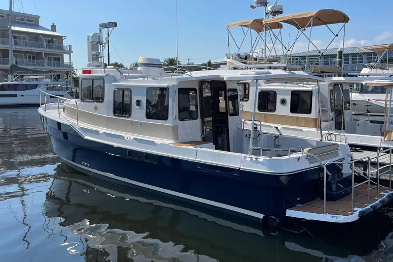 The Image of 2025 Ranger Tugs R-31 S boat docked in marina, featuring sleek design and modern amenities. - 0