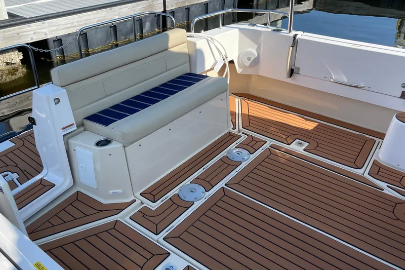 Slide: The Image of 2025 Ranger Tugs R-31 S boat deck with seating and wood-style flooring. - 15