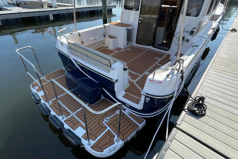 Slide: The Image of 2025 Ranger Tugs R-31 S boat docked, featuring spacious deck and modern design. - 18