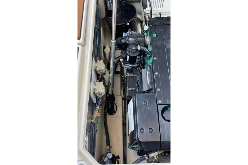 Slide: The Image of Engine compartment of 2025 Ranger Tugs R-31 S, showcasing mechanical components and wiring. - 21