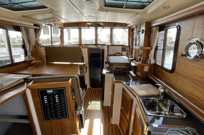 Slide: The Image of Interior of 2025 Ranger Tugs R-31 S, featuring wood finishes and modern amenities. - 24