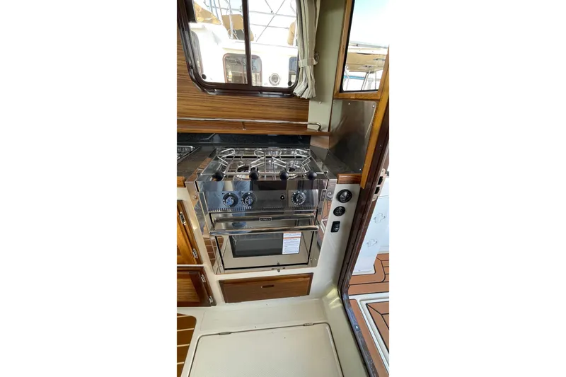 Slide: The Image of 2025 Ranger Tugs R-31 S galley with stainless steel stove and oven. - 25