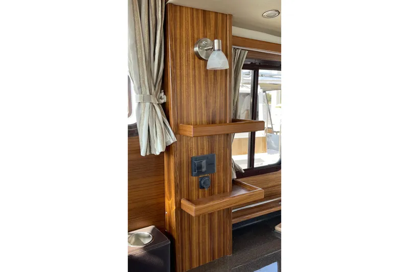 Slide: The Image of Interior of 2025 Ranger Tugs R-31 S with wood paneling and modern light fixture. - 32