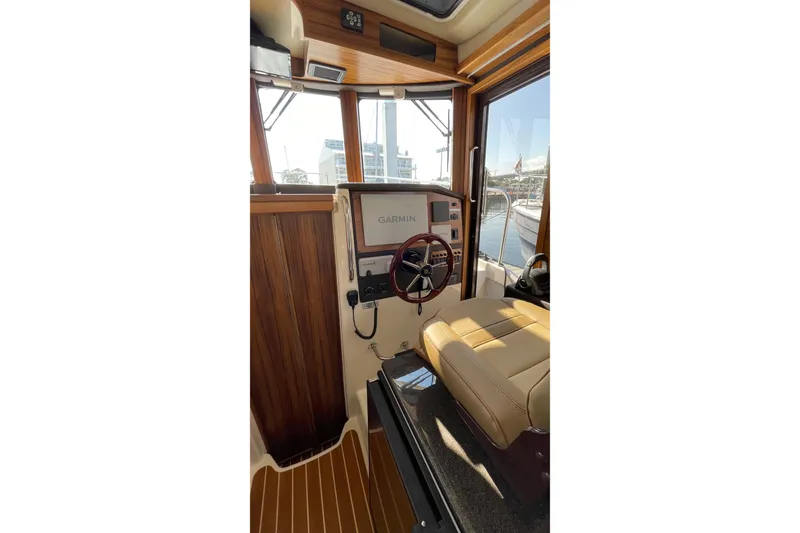 Slide: The Image of Interior of 2025 Ranger Tugs R-31 S boat with Garmin navigation system and wooden accents. - 39