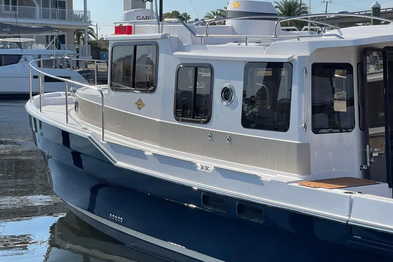 Slide: The Image of 2025 Ranger Tugs R-31 S boat docked, showcasing sleek design and modern features. - 4