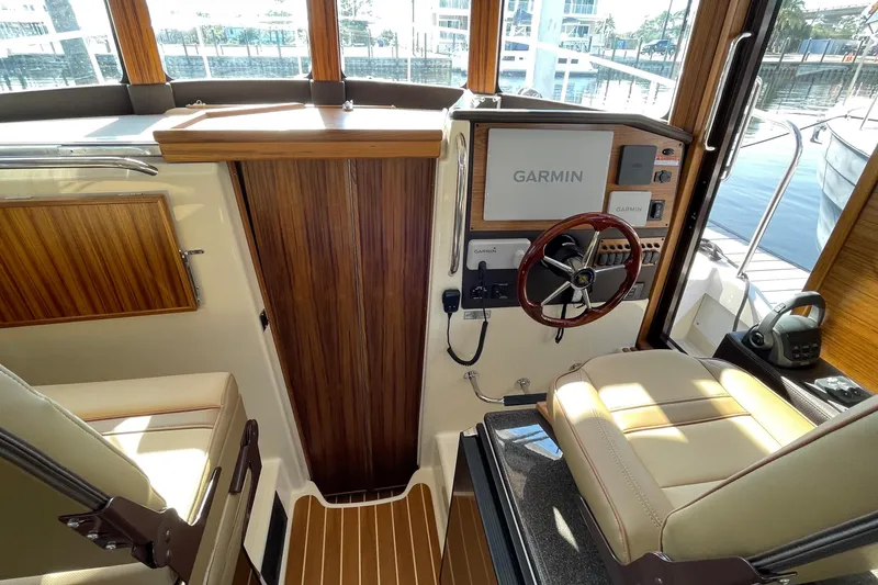 Slide: The Image of Interior of 2025 Ranger Tugs R-31 S with Garmin navigation system and wooden accents. - 40