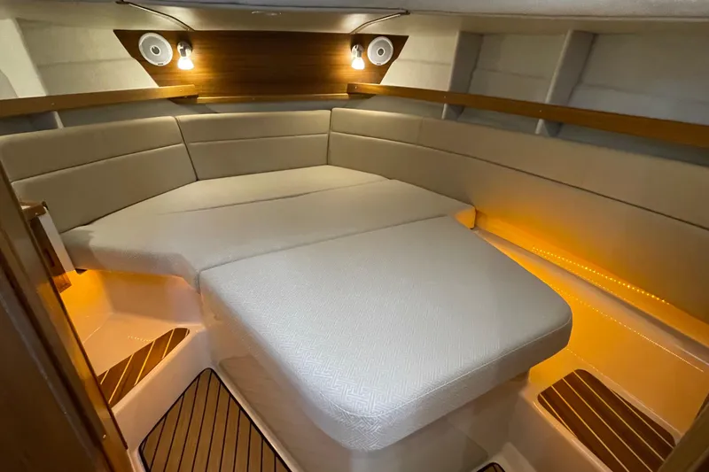 Slide: The Image of 2025 Ranger Tugs R-31 S cabin interior with cozy lighting and elegant wood accents. - 41