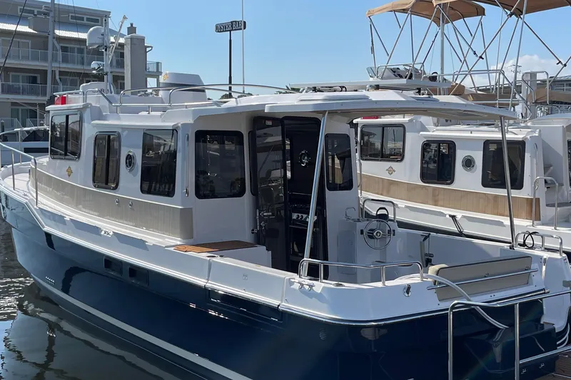 Slide: The Image of 2025 Ranger Tugs R-31 S boat docked at marina, featuring sleek design and modern amenities. - 6