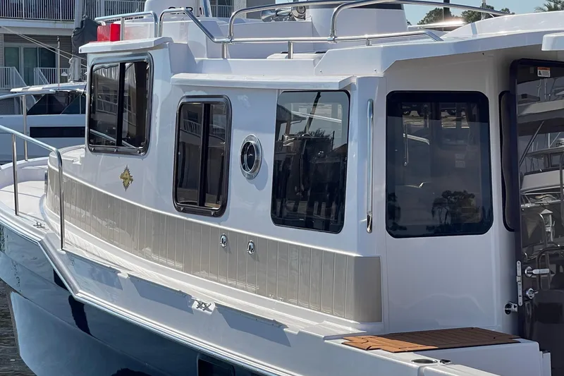 Slide: The Image of 2025 Ranger Tugs R-31 S boat, sleek design, docked at marina. - 7