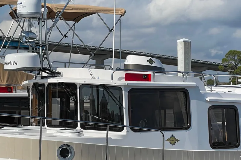Slide: The Image of 2025 Ranger Tugs R-31 S boat with navigation equipment and sleek design. - 8