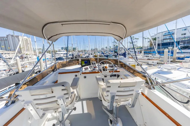 Slide: The Image of Flybridge view of 2000 Sabre 34 yacht in marina, featuring helm and seating. - 15