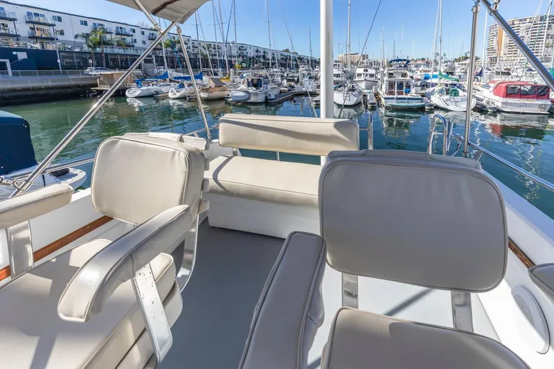 Slide: The Image of Flybridge view of 2000 Sabre 34 yacht in marina, featuring comfortable seating. - 18