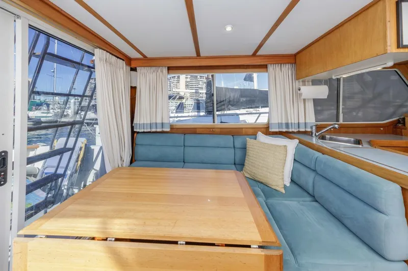 Slide: The Image of Interior of 2000 Sabre 34 Flybridge yacht with cozy seating and dining area. - 24