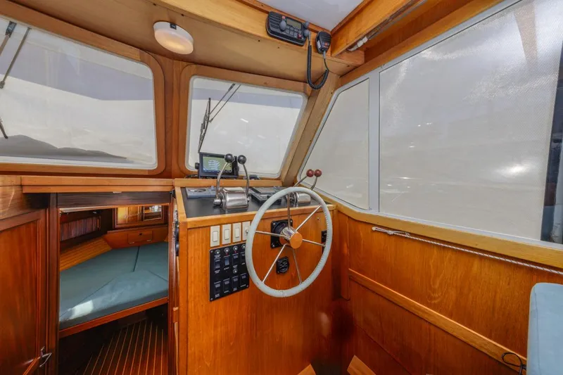 Slide: The Image of Interior of 2000 Sabre 34 Flybridge boat with wooden helm and steering wheel. - 26