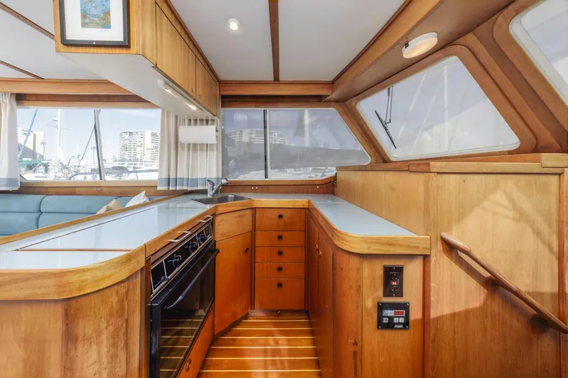 Slide: The Image of Interior of 2000 Sabre 34 Flybridge yacht with wooden cabinetry and modern appliances. - 28