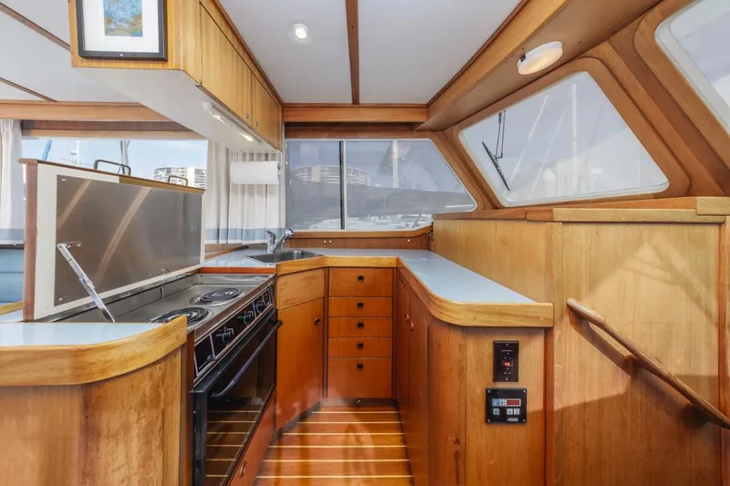 Slide: The Image of Interior of 2000 Sabre 34 Flybridge yacht with wooden cabinetry and modern kitchen. - 29