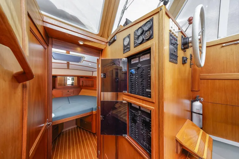 Slide: The Image of Interior of 2000 Sabre 34 Flybridge yacht with wood paneling and control panel. - 30