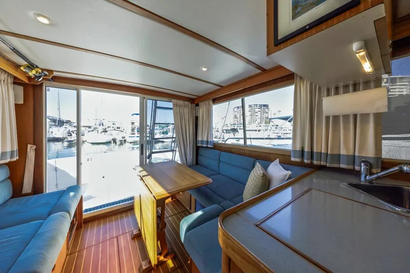 Slide: The Image of Interior of 2000 Sabre 34 Flybridge yacht with marina view through large windows. - 38