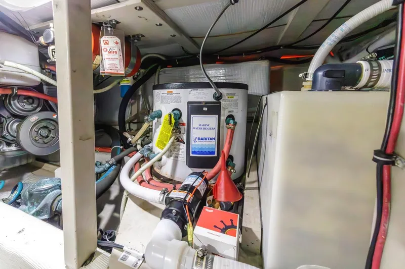 Slide: The Image of Engine room of 2000 Sabre 34 Flybridge with marine water heater and various components. - 39