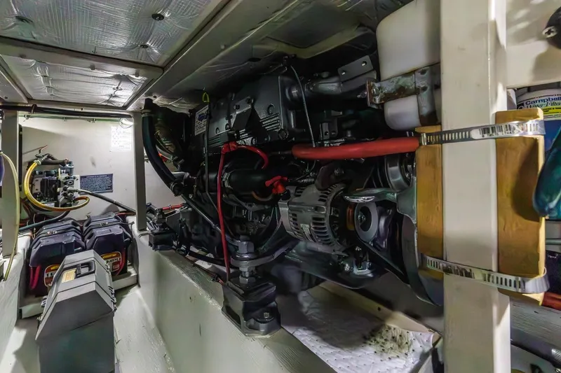 Slide: The Image of Engine room of 2000 Sabre 34 Flybridge, showcasing mechanical components and battery setup. - 40