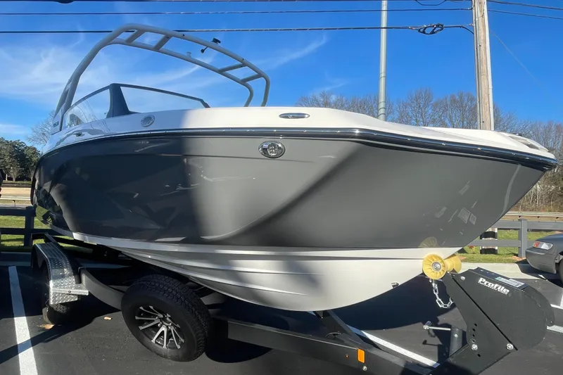 The Image of 2025 Yamaha Boats 222SD on trailer, sleek design, gray and white exterior. - 0