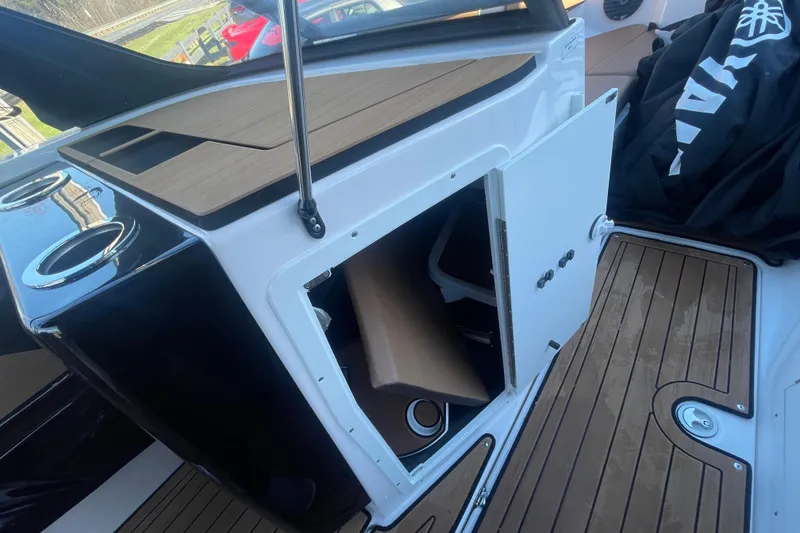 Slide: The Image of 2025 Yamaha Boats 222SD interior with open storage compartment and wood-style flooring. - 12