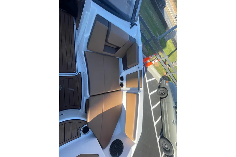 Slide: The Image of 2025 Yamaha Boats 222SD interior with tan seating and wood accents. - 14