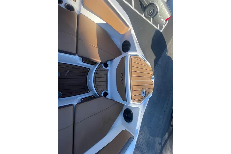 Slide: The Image of 2025 Yamaha Boats 222SD interior with brown seating and wood accents. - 15
