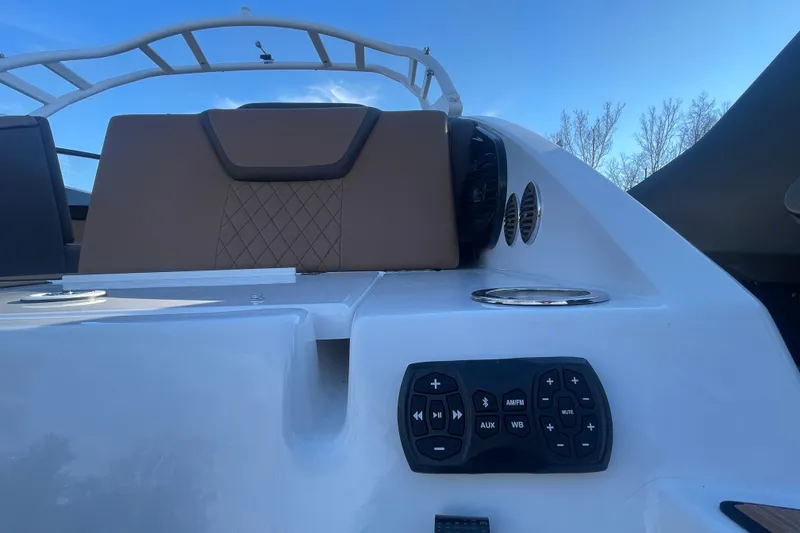 Slide: The Image of 2025 Yamaha Boats 222SD interior with control panel and seating, under clear blue sky. - 4