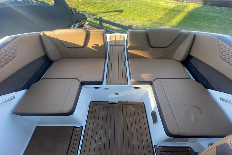 Slide: The Image of 2025 Yamaha Boats 222SD interior with tan seating and wood-style flooring. - 6