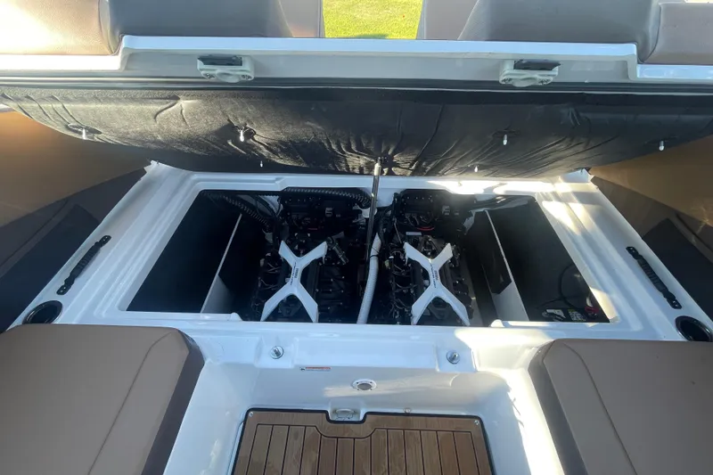 Slide: The Image of 2025 Yamaha Boats 222SD engine compartment with dual engines and seating area. - 7