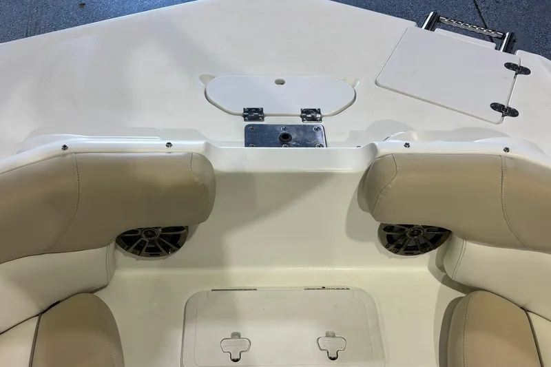 Slide: The Image of 2015 NauticStar 223DC Sport Deck boat interior with beige seating and speaker system. - 13