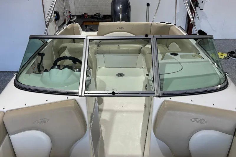 Slide: The Image of 2015 NauticStar 223DC Sport Deck boat interior with seating and steering wheel. - 14