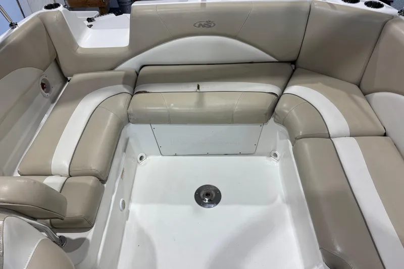 Slide: The Image of 2015 NauticStar 223DC Sport Deck boat interior with beige and white seating. - 15