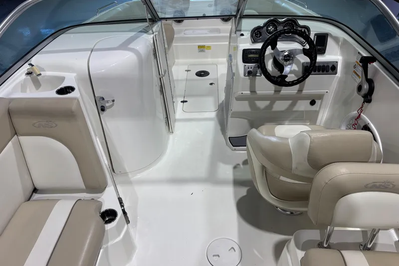 Slide: The Image of 2015 NauticStar 223DC Sport Deck interior with steering wheel and seating. - 6