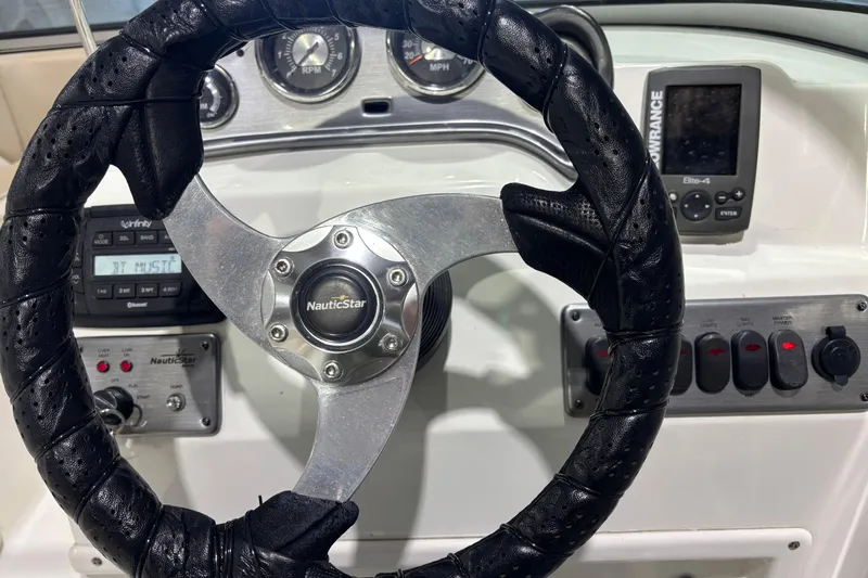 Slide: The Image of Steering wheel and dashboard of 2015 NauticStar 223DC Sport Deck boat. - 8